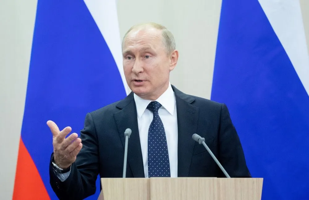 Vladimir Putin appears to be in pain as he repeatedly rubs his hands