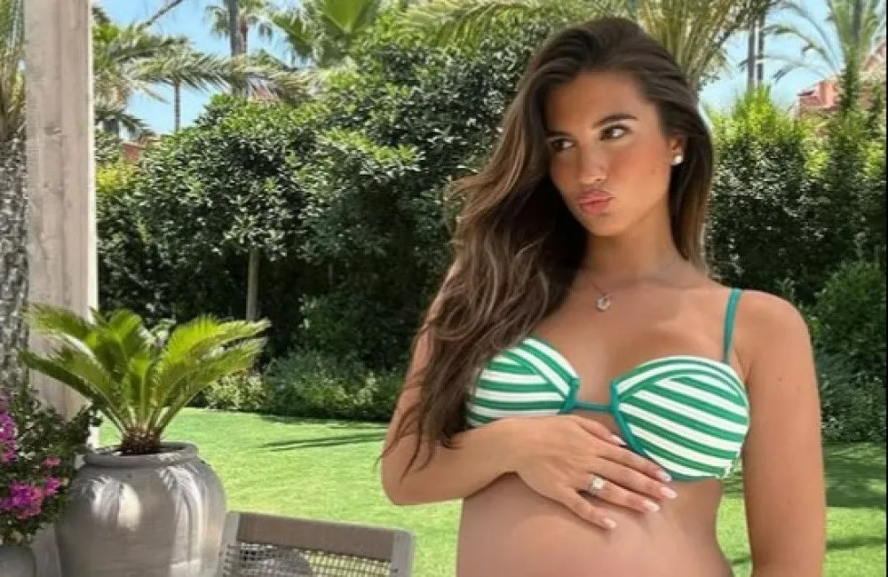 Karen Brady's daughter displays full baby bump in striped green and white bikini