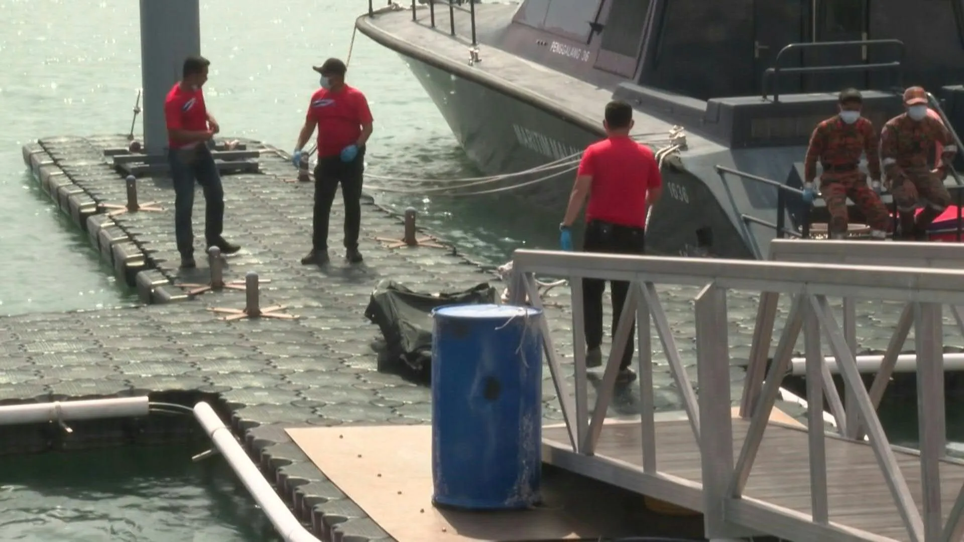 Rescuers recover a body after migrant boat sinks off Malaysia